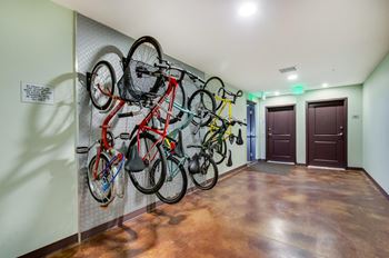 A hallway with a wall of bicycles and a sign on the wall.